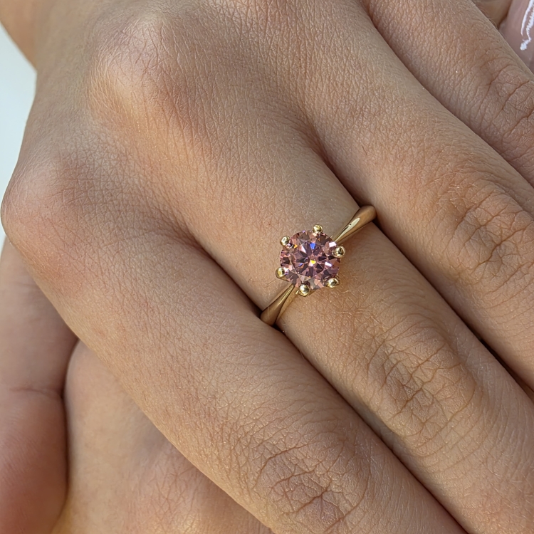 Pierścionek zaręczynowy z żółtego złota próba 585 z różowym moissanitem 0,80 ct – zbliżenie na dłoni – ABGOLD Baczyński