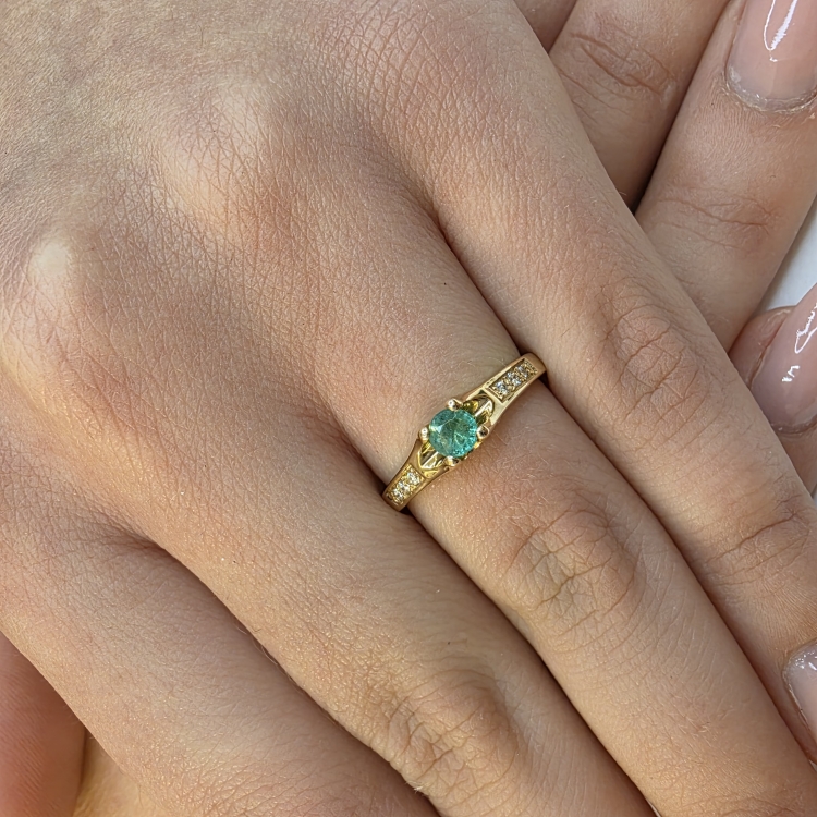 Pierścionek zaręczynowy z szmaragdem i diamentami – na dłoni, zbliżenie – ABGOLD Baczyński